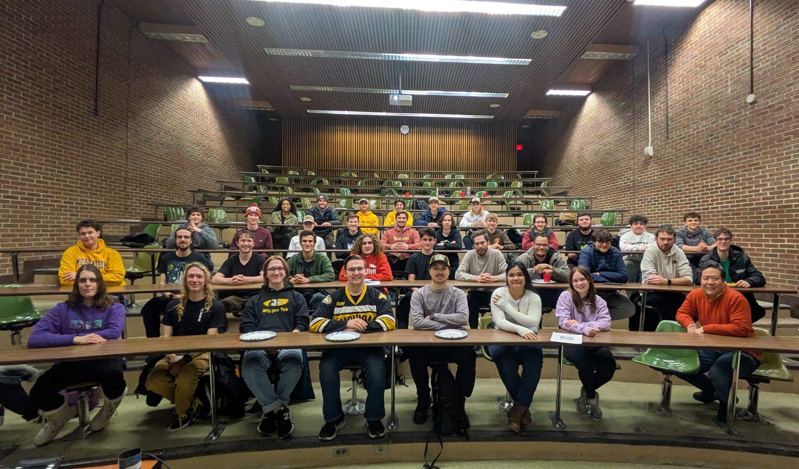 students sitting at tables lined up in a classroom